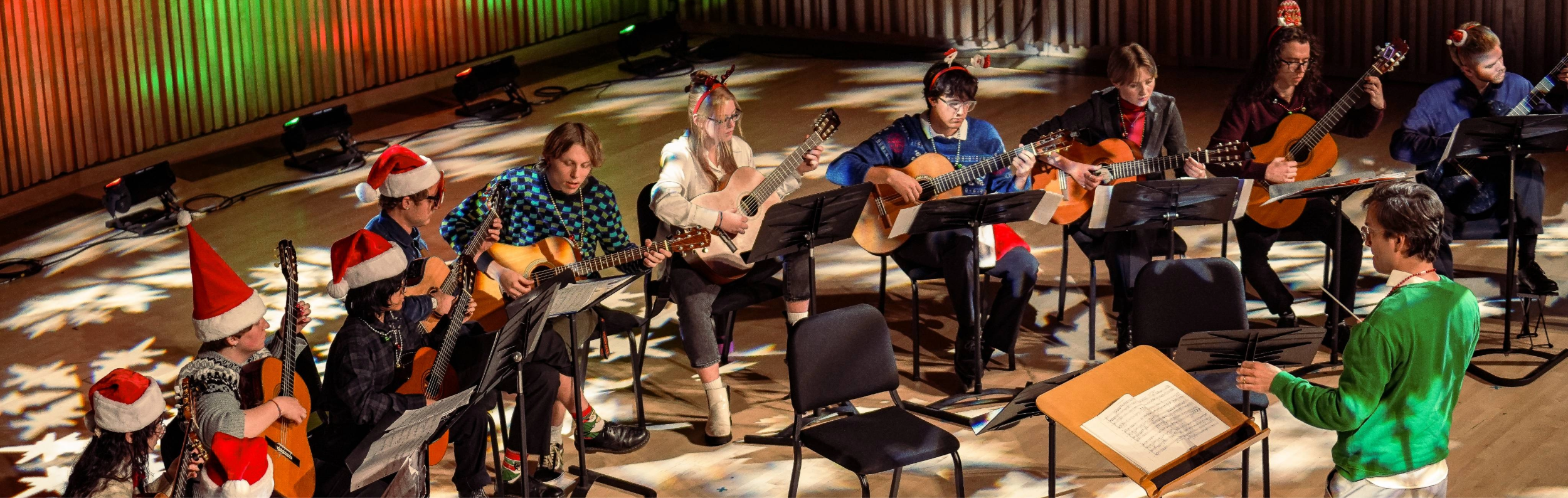 Students performing in PRAx as part of guitar ensemble