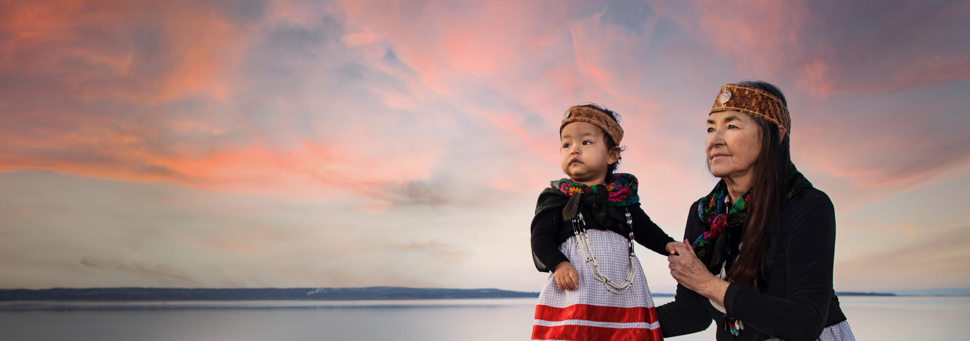 Matika Wilbur standing with a child at sunset