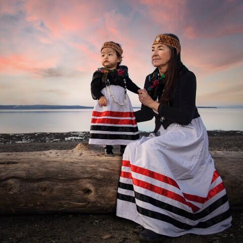 Matika Wilbur standing with a child at sunset